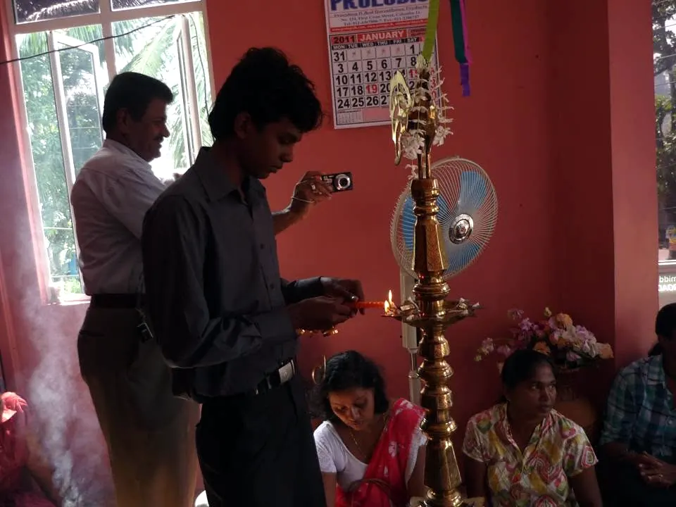 Lighting the oil lamp at our office opening